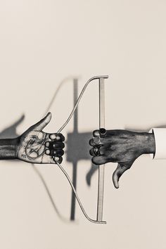 two hands are holding a bow and arrow