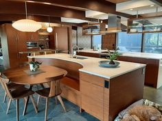 a large kitchen with an island and dining room table