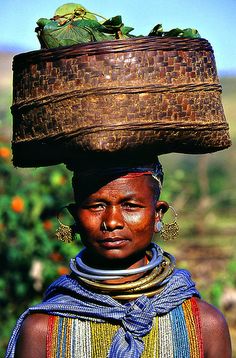 a woman with a basket on her head