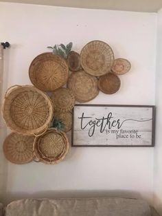 some baskets are hanging on the wall next to a sign that says together, my favorite place to be