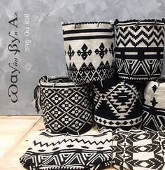 several woven baskets sitting on top of a wooden table