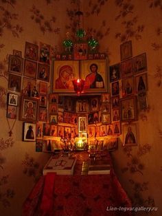 a room with pictures and candles on the wall