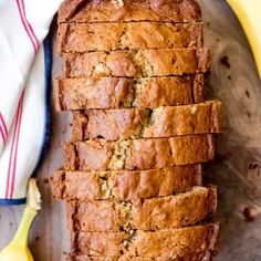 sliced loaf of banana bread sitting on top of a cutting board