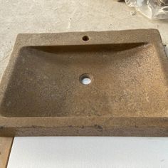 a square sink sitting on top of a counter