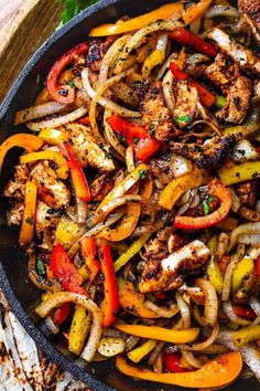 chicken fajita with peppers and onions in a skillet