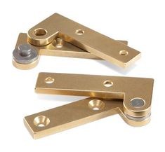 two brass plated metal brackets with screws