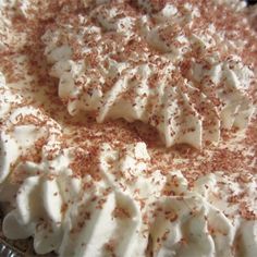 a cake with white frosting and sprinkles on top