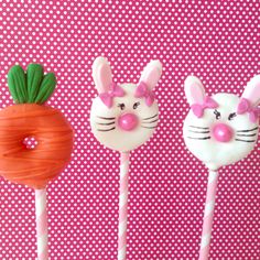 three cake pops decorated to look like bunnies and carrots with faces on them