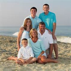 a family poses for a photo on the beach