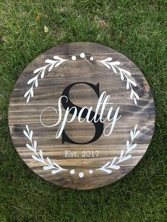 a wooden sign with the word spaty painted on it in white and black ink