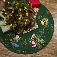 a christmas tree with presents under it on the floor