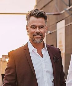 a man in a brown suit and white shirt