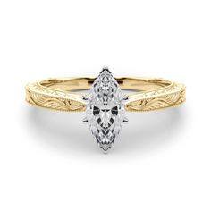 a yellow gold engagement ring with a pear shaped diamond