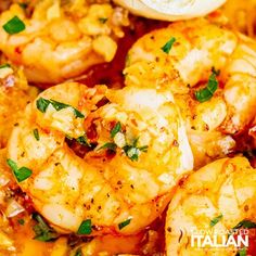 cooked shrimp with tomato sauce and herbs in a pan