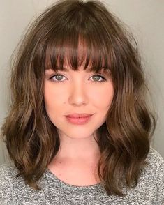 15. See-Through Bangs for Wavy Hair. Round face haircuts with bangs work as a perfect frame for your features. Longer bangs that fall over the eyebrows hide the forehead, shifting the focus to the eyes. Shoulder Length Bob Haircut, Latest Bob Hairstyles, Cute Bangs, Bangs For Round Face, Bangs Hairstyles, Bangs With Medium Hair, Medium Short Hair