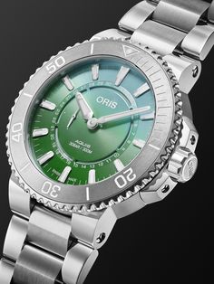 Oris continues its partnership with the Common Wadden Sea Secretariat, an organisation that works to conserve the Wadden Sea in northern Europe, on this second limited-edition model, the 'Aquis Dat Watt' diver's watch. Featuring a green dial inspired by the waters of the salt marshes, this automatic stainless steel reference has an innovative date window ring, unidirectional rotating tungsten bezel and Super-LumiNova® coating for underwater legibility. It's one of 2, 009 made, coinciding with t… Green Watch With Subdials, Timeless Green Analog Watch, Timeless Green Watch With Analog Display, Green Round Chronograph Watches, Green Chronograph Round Watch, Green Chronometer Watch With Round Dial, Green Chronometer Watch Accessories With Round Dial, Timeless Green Automatic Watch, Timeless Green Chronograph Watch With Analog Display