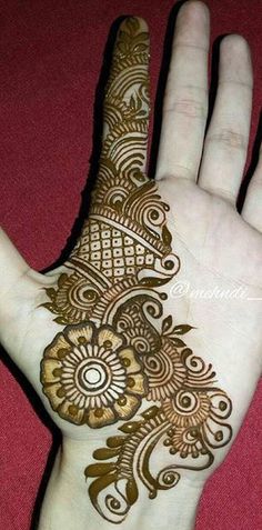 the hand is decorated with henna and flowers