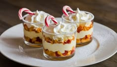 three desserts on a plate with candy canes