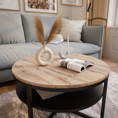 a living room with a blue couch and coffee table in the middle, next to a newspaper