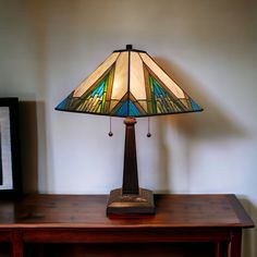 a lamp sitting on top of a wooden table