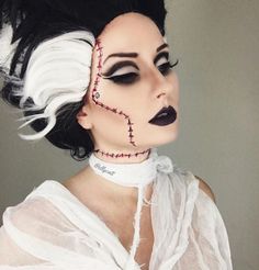 a woman with black hair and white makeup