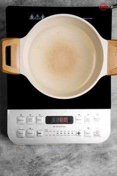 a frying pan sitting on top of a stove with the timer turned to 4 o'clock