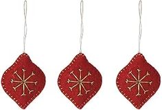 three red christmas ornaments hanging from strings on a white background with snowflakes in the middle