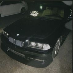 a black car parked in front of a white car