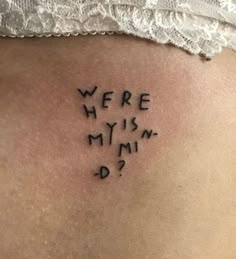 the back of a woman's stomach with words written in cursive writing