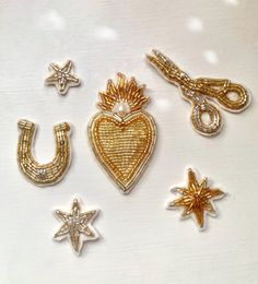 several different types of brooches on a white surface