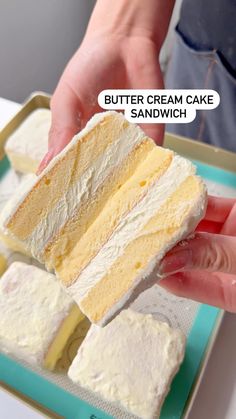 a person holding a piece of cake in their hand with the words butter cream cake sandwich above it