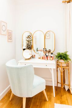 a white desk with two mirrors and a chair