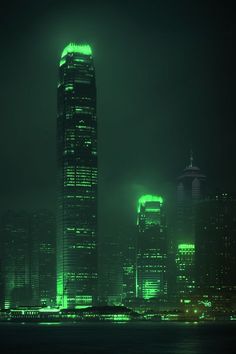 the city skyline is lit up in green for st patrick's day