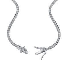 The epitome of understated elegance. A row of 2mm round cut premium zirconia stones meticulously set on a pure sterling silver chain using a 4 prong setting featuring a double clasp push safety closure. A classic design and quality craftsmanship made to surpass the trends and test of time. Timeless Sterling Silver Tennis Necklace, Timeless Sterling Silver Tennis Necklace With Round Cut, Everyday Luxury Silver Tennis Necklace Vvs Clarity, Dazzling Tennis Necklace With Prong Setting, Timeless Tennis Necklace With Brilliant Cut Cubic Zirconia, Fine Jewelry Tennis Necklace With Prong Setting, Timeless Sterling Silver Diamond Cut Tennis Necklace, Timeless Silver Tennis Necklace With Diamond Accents, Classic Single Strand Cubic Zirconia Tennis Necklace