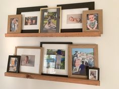 three wooden shelves with pictures and frames on them