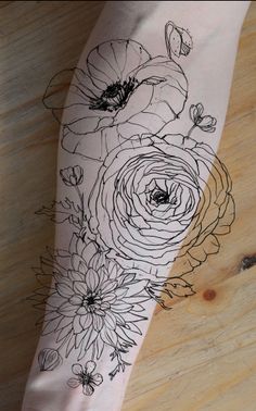 a woman's arm with flowers on it