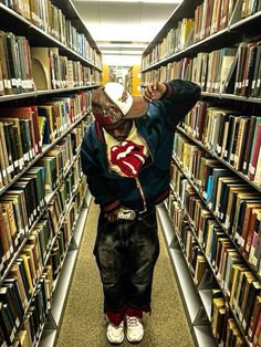 a person standing in front of a book shelf filled with books and wearing a superman costume