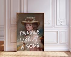 a painting with the words fragile like or a bomb on it in front of a white wall