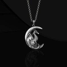 "Silver Moon Dragon Necklace The dragon is the spirit of change, eternity and transformation! There are countless legends, legends, epics and myths for dragons, the protagonist of the beliefs and mythologies of ancient societies. Societies glorified, worshiped, feared her, offered gifts or sacrifices. Calendars were adjusted according to the dragon, and a constellation in the sky was named after her. The traces of the dragon in the depths of the human soul have been the subject of research in psychology, and also took its place in esoteric teachings. While eastern cultures saw dragons as wise gods, representing benevolence and benevolent creatures, western civilizations viewed dragons as fearsome monsters, often evil. Dragons, which are still the subject of many movies, books and works of Fantasy Moon Shaped Jewelry Gift, Silver Dragon Design Jewelry For Fantasy Events, Fantasy Silver Jewelry With Moon Charm, Silver Engraved Jewelry For Costume Events, Esoteric Teachings, Moon Dragon, Constellations In The Sky, Head Necklace, Pendant For Men