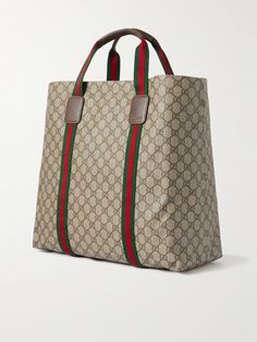 The monogram decorating Gucci's 'GG Supreme' coated-canvas is one of fashion's most recognisable hallmarks. Crafted in Italy, this tote bag is made from monogrammed 'Tender' canvas trimmed with signature red and green webbing. Store your essentials in the handy internal zip pocket. Gucci Rectangular Monogram Canvas Bag, Gucci Monogram Canvas Rectangular Bag, Gucci Coated Canvas Bag With Logo, Designer Gucci Monogram Canvas Bag, Modern Monogram Print Rectangular Bags, Gucci Designer Bags In Coated Canvas, Designer Gucci Bags In Coated Canvas, Designer Gucci Coated Canvas Bags, Luxury Gucci Bag In Coated Canvas