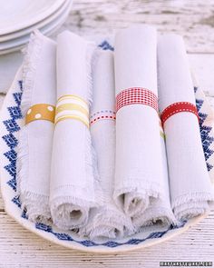 four white napkins on a blue and white plate