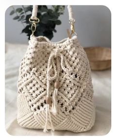 a crocheted white purse sitting on top of a bed