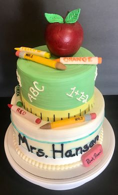 there is a cake made to look like an apple on top of a stack of books