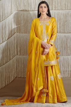 Featuring a mustard short kurta in chanderi base with gota embroidery. It is paired with matching sharara pants and a georgette dupatta.  FIT: Fitted at bust and waist. COMPOSITION: Chanderi, Georgette. CARE: Dry clean only. Yellow Suit For Haldi Function, Suit For Haldi, Haldi Function Dress, Kurta Skirt, Gota Embroidery, Embroidered Sharara, Mustard Fabric, Kurta Sharara Set, Function Dresses