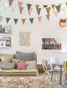 a living room filled with lots of furniture and decor on top of a carpeted floor