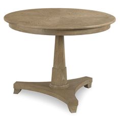 a round wooden table with an intricate design on the top and base, against a white background