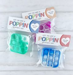 three bags of poppin's are sitting on a table with some candy in them