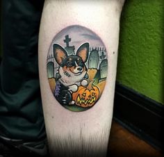 a dog with a jack o lantern tattoo on his leg