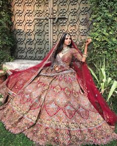 a woman in a red and gold wedding dress