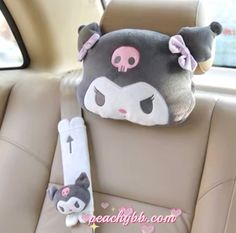 a car seat with a stuffed animal head on the back of it's head